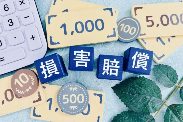 交通事故の慰謝料を書類と電卓で確認するイメージ
